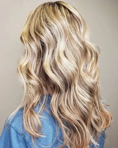 Warm blonde balayage in soft waves.